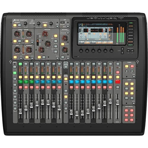 Digital audio mixer console with multiple sliders and controls.