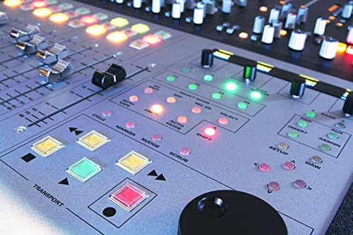 Close-up of an audio mixing console with various buttons and knobs.