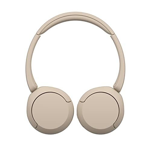 Beige wireless over-ear headphones on white background.