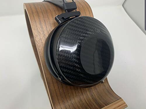 Carbon fiber headphones on a wooden stand.