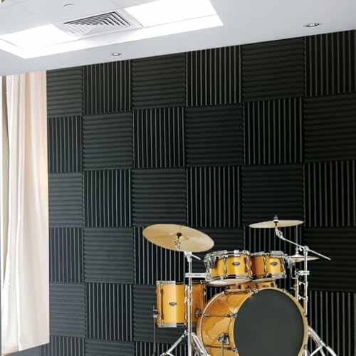 Drum set in a soundproof room with acoustic panels.