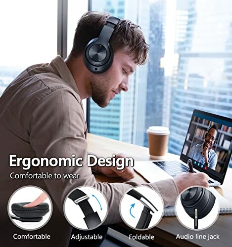 Man wearing headphones working on a laptop with ergonomic design features displayed.