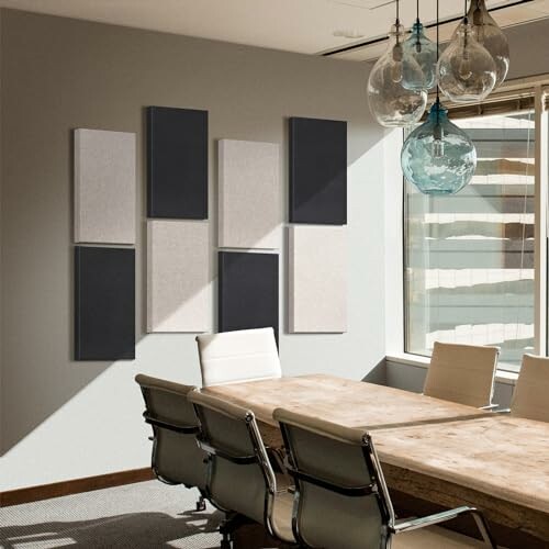 Modern conference room with wooden table, white chairs, wall art, and hanging lights.