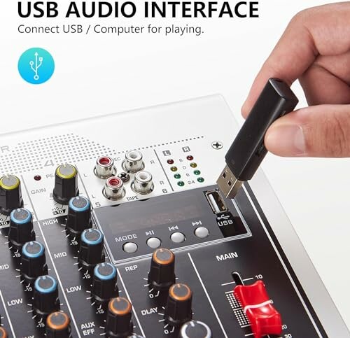 Person connecting USB audio interface to mixer