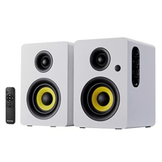 Pair of white bookshelf speakers with remote control.