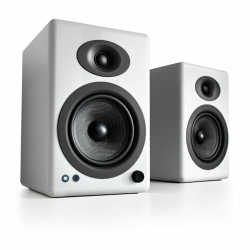 Two white stereo speakers with black accents.